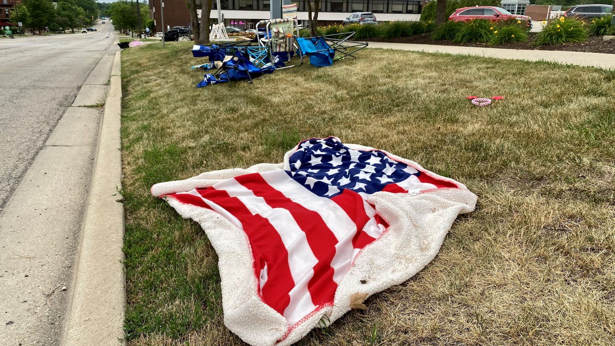 An American flag blanket was left in downtown Highland Park, Ill., on July 4.