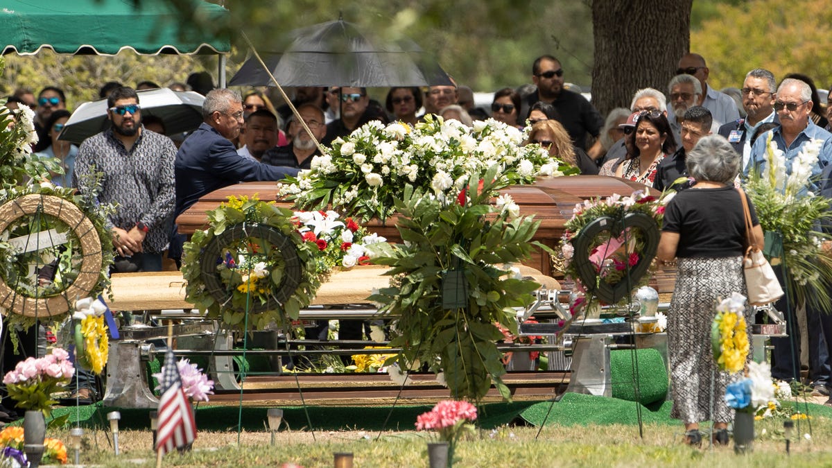 Mourners pay their respects at the funeral for Irma and Jose Garcia at Hillcrest Memorial Cemetery in Uvalde on Wednesday June 1, 2022. Irma was a teacher at Robb Elementary School and was killed when a shooter entered the school, killing 19 students and 2 adults. Jose Garcia died of a heart attack in the days following the shooting.