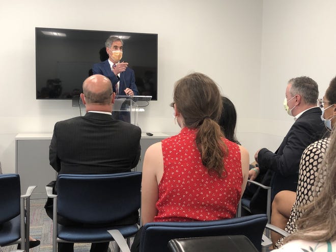 Dr. Joseph W. St. Geme, physician-in-chief at the Children's Hospital of Philadelphia, speaks at a conference at the CHOP Primary Care center in Doylestown where Congressman Brian Fitzpatrick (seated at right) discussed legislation to improve mental health care for children and adolescents.