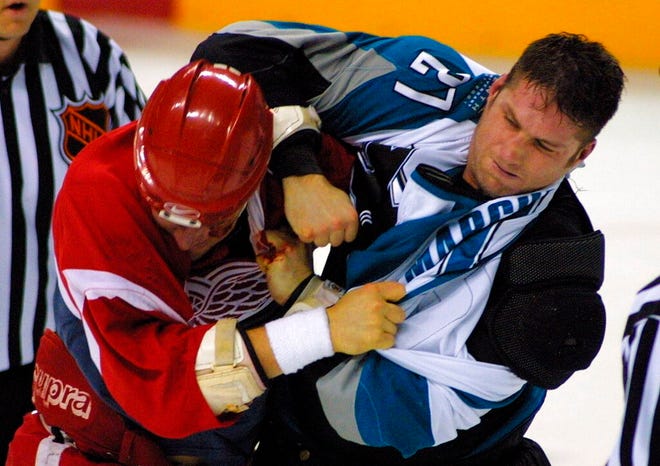 Red Wings forward Darren McCarty, left, fights Sharks defenseman Bryan Marchment during a 2001 game in San Jose, Calif. Marchment died unexpectedly Monday in Montreal. He was 53.