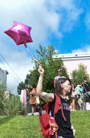 Sonnie Bane, 30, holds a pink balloon in support of abortion outside of the Jackson Women’s Health Organization on the last day the clinic is legally allowed to be open in Jackson, Miss., Wednesday, July 6, 2022.