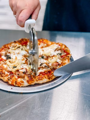 Make your own pizza at Bullseye Pizza in Seymour on July 1, 2022.
