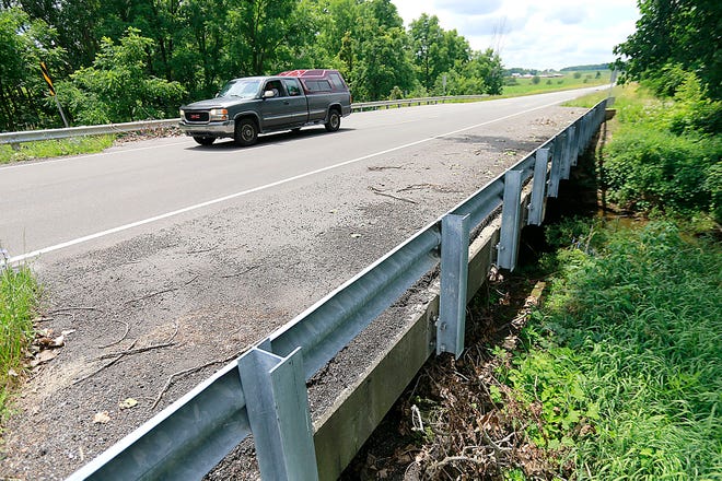 A vehicle travels east on County Road 30A over the bridge at Oldtown Run. Ashland County Commissioners approved a bid of nearly $800,000 to replace the bridge at Thursday's meeting. A state grant is funding nearly half the cost of the project.