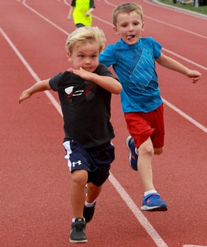 Clive Leahy, of Duxbury, just edges out Marshfield's Arthur Salzsieder for first in the 50-meter dash during the Marshfield Road Runners Youth Track Meet at Marshfield High on Wednesday, July 31, 2019. [Wicked Local Staff Photo/ Robin Chan]