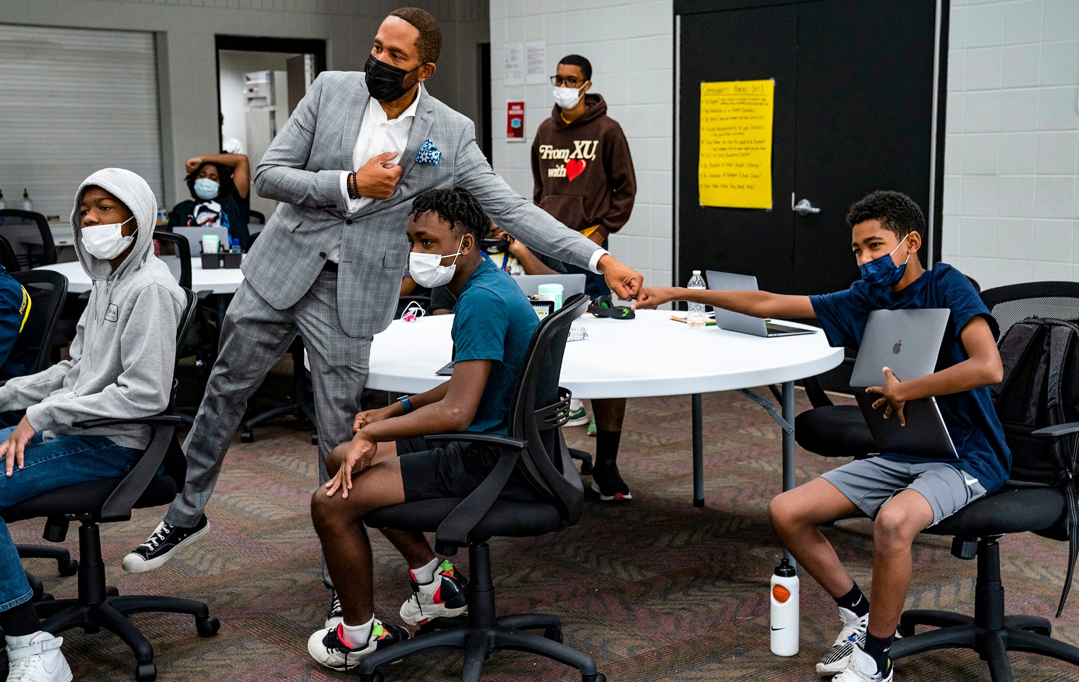 The Hidden Genius Project Detroit site director William Malcolm, left, fist bumps Kameron Patterson, 13, of Southfield during a discussion at the Hidden Genius Project at the Dick & Sandy Dauch Campus of the Boys & Girls Club of Southeast Michigan in Detroit, Thursday, July, 7, 2022. The Hidden Genius Project is a national program with a 10-year history but Detroit is a new edition for the project this year and targets young black men entering the 9th, 10th, and 11th grades with the goal of transforming the lives of the participants with the belief that they will be able to transform the communities they come from. The program focuses on mentorship, entrepreneurship, tech exposure, leadership, career development etc.