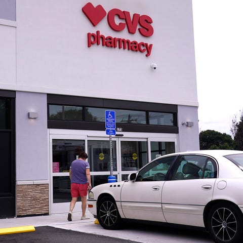 A customer walks into a CVS Pharmacy store, Tuesda