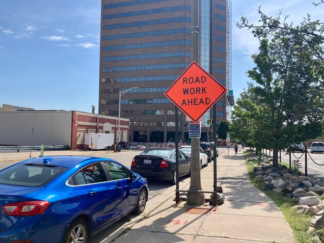 Signs warning drivers of road work are plentiful in downtown Lansing this summer. Here, a sign on Washtenaw Street, photographed on July 7, 2022, indicates the construction ahead on Grand Avenue.