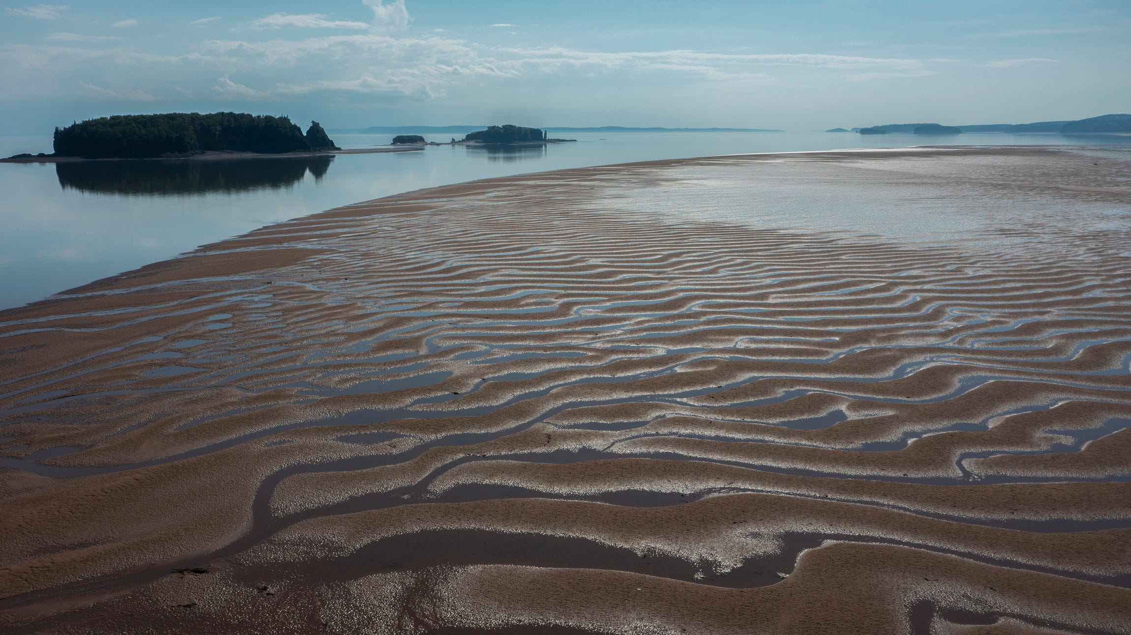 A receding tide is seen leaving the Bay of Fundy in Nova Scotia, Canada, in late June 2022.