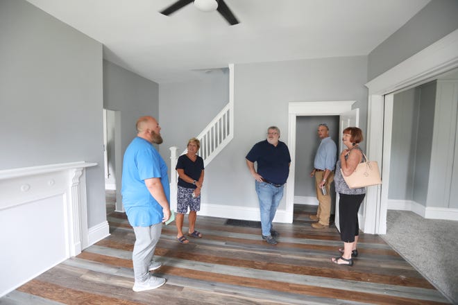 Muskingum County Commissioner Mollie Crooks, right, Muskingum County Land Bank Executive Director Andrew Roberts, Councilman Rob Sharrer and Commissioner Cindy Cameron meet with Terry Bocook, left. Bocook purchased the home at 430 Luck Ave. from the land bank and rehabilitated the property.