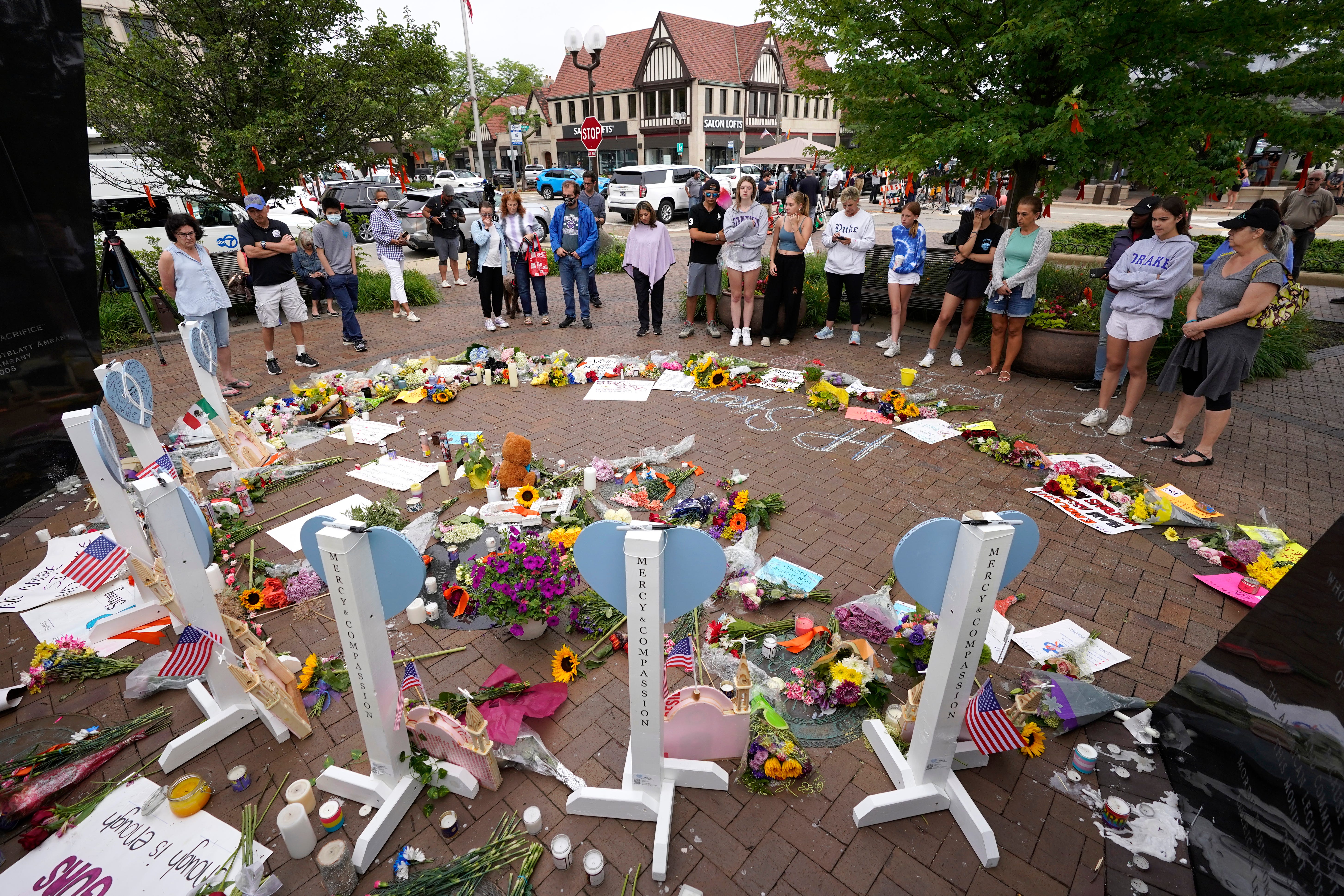 Area residents visit a memorial to the seven people who lost their lives in the Highland Park, Ill., Fourth of July mass shooting, Wednesday, July 6, 2022, in Highland Park. (AP Photo/Charles Rex Arbogast) ORG XMIT: ILCA131