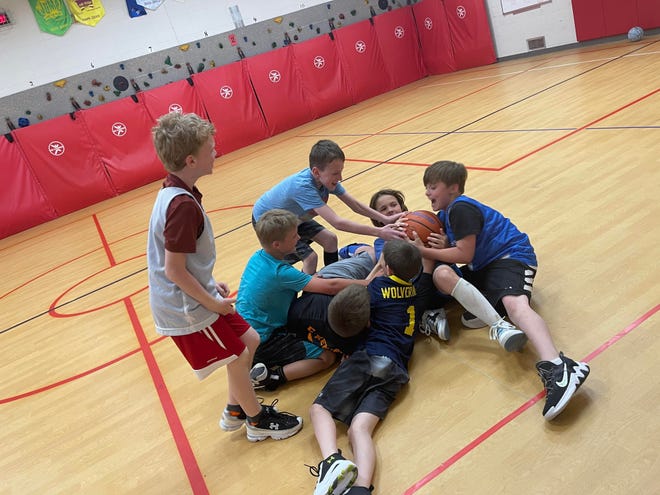 Carson Dunn having some fun nabbing the basketball from his teammate.