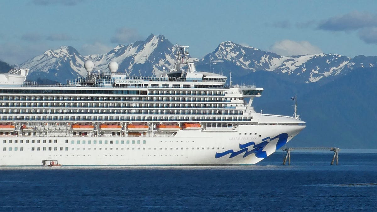 FILE - This May 30, 2018, file photo shows the Grand Princess cruise ship in Gastineau Channel in Juneau, Alaska. Several cruise lines said Wednesday, May 6, 2020, they are canceling sailings to Alaska this summer, citing travel and other restrictions linked to coronavirus concerns. Two of the companies, Princess Cruises and Holland America Line, had previously announced sharply reduced plans for voyages to and tours in Alaska.  (AP Photo/Becky Bohrer, File)