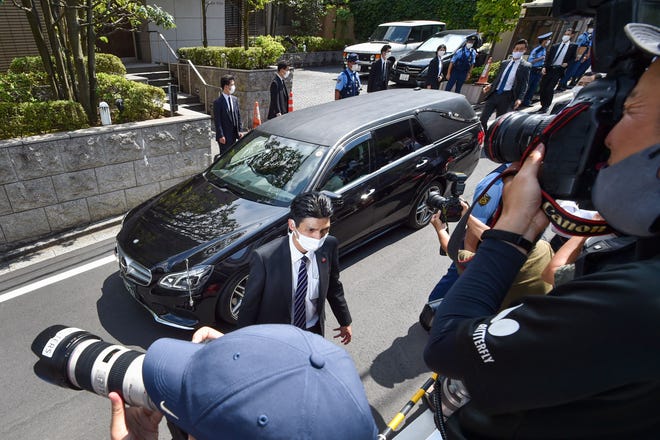 A hearse transporting the body of former Japanese prime minister Shinzo Abe arrives at his residence in Tokyo on Saturday, July 9, 2022. Abe died after being shot at a campaign event in the Japanese city of Nara on July 8, 2022.