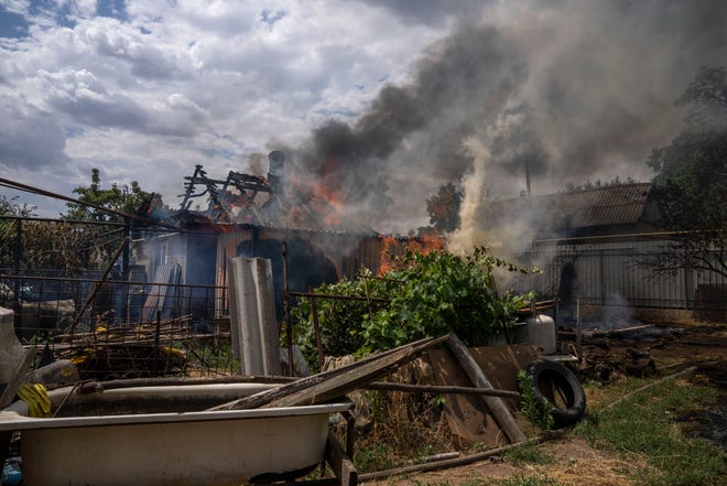 Smoke rises from a house caught on fire, after cluster rockets hit a residential area, in Konstantinovka, eastern Ukraine, Saturday, July 9, 2022.