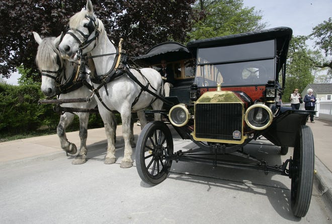 A horse draw omnibus stands next to a 1914 Model T Family Touring car at Greenfield Village, part of The Henry Ford in Dearborn on May 8, 2008.