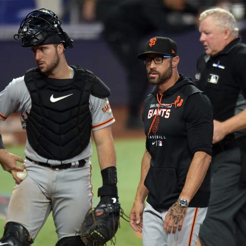 Catcher Joey Bart and manager Gabe Kapler react at