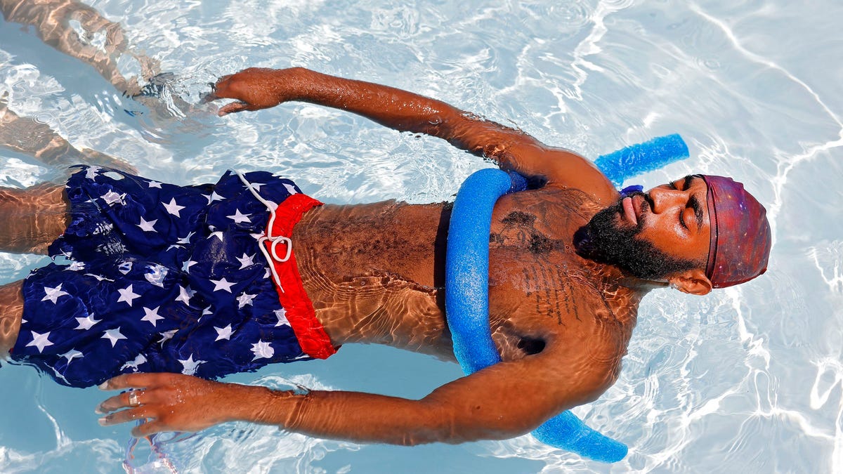 Yonny Hodges floats in the Lacy Park Pool, Friday, July 8, 2022 in Tulsa, Okla. It is the 5th day in a row for temperatures of 100 degrees Fahrenheit or more, the first time since July 2012.