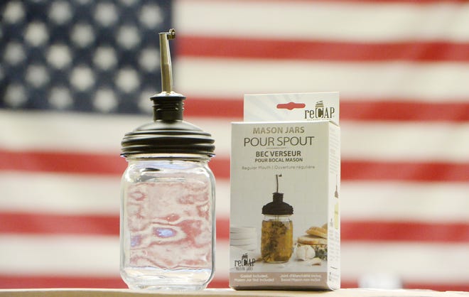 A pour spout offered by ReCap Mason Jars is displayed inside the company's fulfillment center in Millcreek Township on July 11, 2022. 