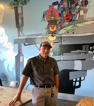 Co-founder and head brewer Bill diMario spent over 30 years as an engineer before opening Thirsty Robot. Images of robots abound inside his garage taproom.