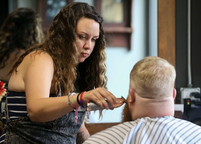 Jessica Nelson, owner of Beards & Shears in Marshfield, trims Eric Halbur’s beard on July 7. Nelson opened her business in August 2020 and provides men’s hairstyling and beard grooming.