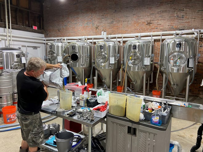 Ron Ware, one of the seven partners at Twisted Vine Brewery, stocks hops for brewing at 112 SE 4th St.  , Des Moines.