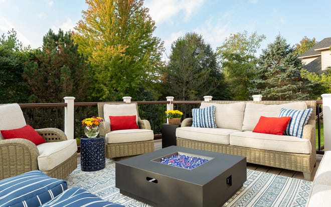 The open-air deck of this Indiana home features furniture with a woven, rattan-like look. The synthetic materials are made for the outdoors, and the upholstery used is made to withstand humidity and major temperature changes.