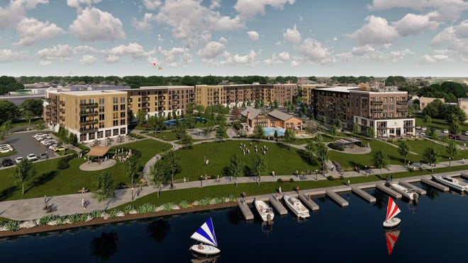 An architectural rendering shows the completed Mill on Main development, viewed looking southwest from the Fox River.