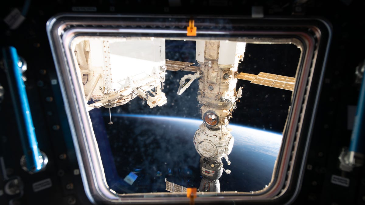 This view from one of seven windows on the International Space Station's cupola shows three Russian components including (from bottom) the Soyuz MS-21 crew ship, the Prichal docking module, and the Nauka multipurpose laboratory module.