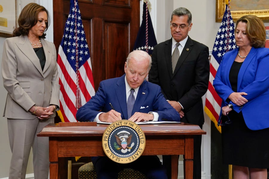 FILE - President Joe Biden signs an executive order on abortion access during an event in the Roosevelt Room of the White House, Friday, July 8, 2022, in Washington as Vice President Kamala Harris, Health and Human Services Secretary Xavier Becerra, and Deputy Attorney General Lisa Monaco watch.