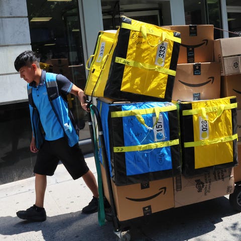 NEW YORK, NEW YORK - JULY 12: An Amazon workers pu