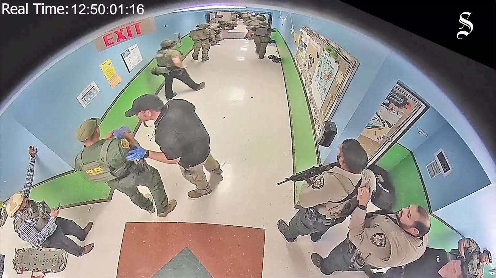 Members of law enforcment wait in the hallway down from the classroom where the gunman is at Robb Elementary School in Uvalde, TX May 24, 2022.