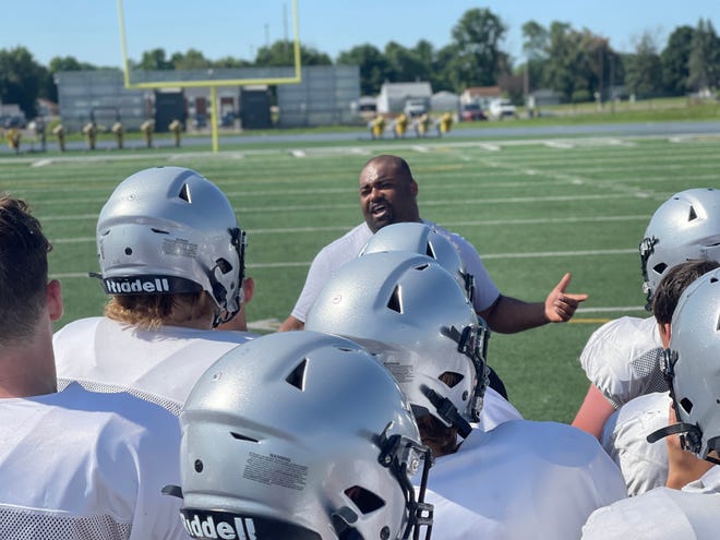 Galesburg High School football coach Derrek Blackwell talks to his squad after Wednesday morning's team camp at Van Dyke Field.