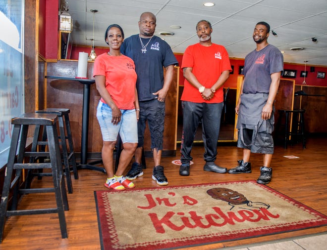Elbert Nickerson Jr. and his wife Shelanda, left, run Jr's Kitchen with help from cooks Kevin Cockrill, right, and Danny Tillman at 1024 W. Main Street in Peoria and a second location at 123 MacArthur Highway.