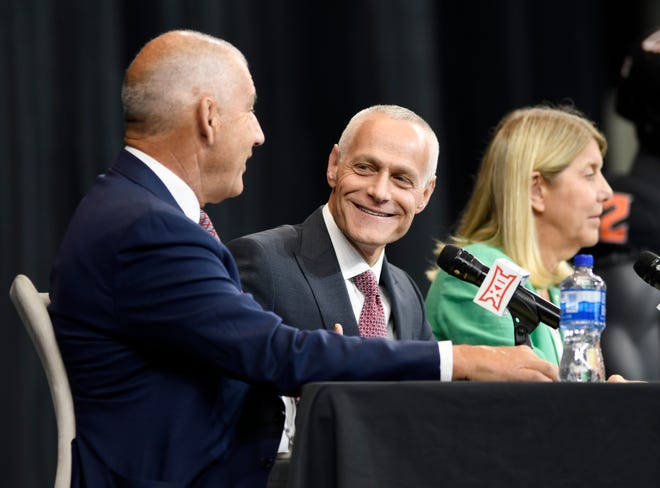 New Big 12 commissioner Brett Yormark, center, speaks with outgoing commissioner Bob Bowlsby on Wednesday at AT&T Stadium in Arlington, Texas.