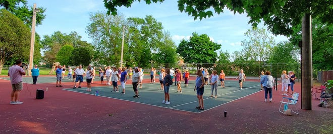 Area residents take part in Line Dancing on the tennis court at St. Mary's Park earlier this summer. The next Line Dancing event is Tuesday. Provided by City of Monroe's Parks and Recreation department