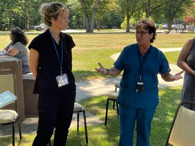 Dental Assistant Julie Michalski and Public Health Dental Hygienist Pamela Collelo, both with the state Department of Developmental Services, talk Wednesday. The clinic was suspended by the department in March, for hiring reasons, and has yet to reopen.