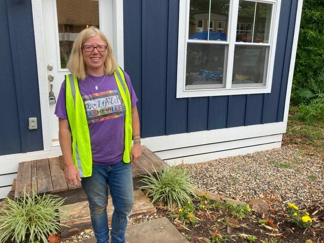 BeLoved Asheville co-director stands outside the BeLoved Village model home in July 2022, the first of 12 deeply-affordable microhomes coming to East Asheville.