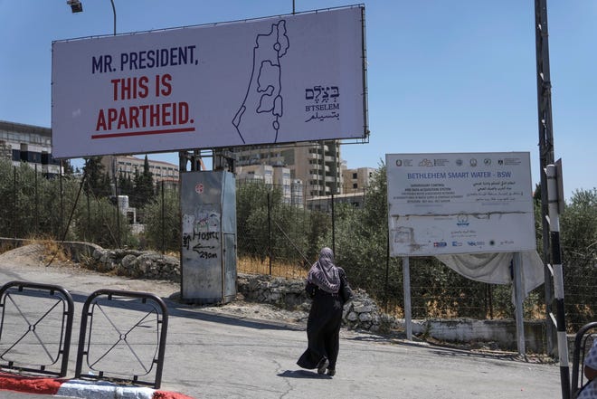 A billboard saying "Mr. President, this is apartheid" is posted by an Israeli human rights group in the West Bank town of Bethlehem ahead of the arrival of President Joe Biden in the region.