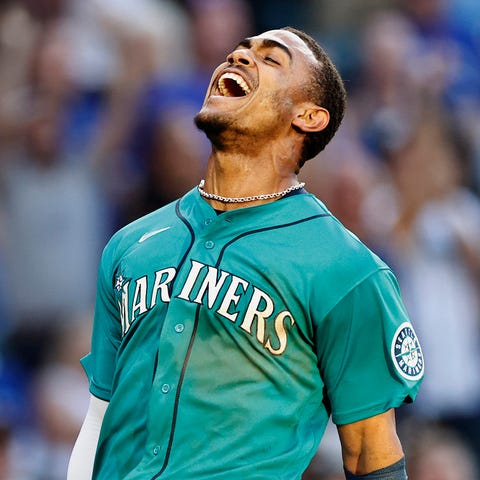 Julio Rodriguez reacts after scoring a run against