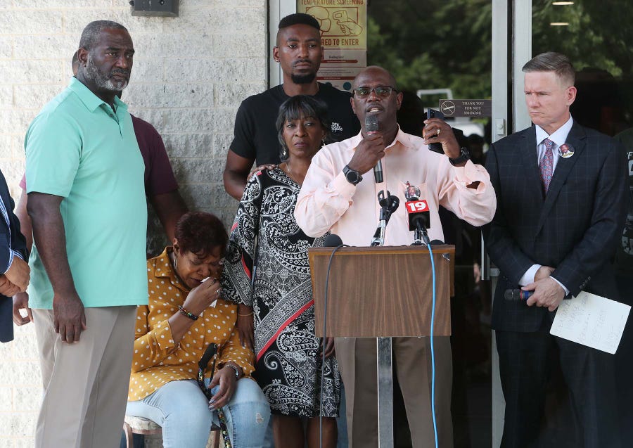 The Rev. Robert DeJournett speaks as he stands between the family of Jayland Walker, left, including Walker's mother, Pamela Walker, seated, and attorney Bobby DiCello who is representing the family, during a press conference at St. Ashworth Temple Church of God in Christ Monday, July 11, 2022 in Akron, Ohio. The family is upset with how the Akron Police Department is dealing with peaceful protesters and also how Walker is being portrayed by the department to the public.