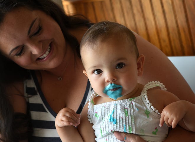 One-year-old Evie Pollzzie could not get enough of blue moon ice cream she enjoyed with her mother, Amy Pollzzie, at Independent Dairy in Monroe. "She is teething," said Amy.