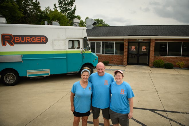 Mary Russell, left to right, Rob Russell and Kayla Mundell stand outside R Burger's new brick-and-mortar location, R Kitchen, at 1006 Person Street, which will be opening by the end of the month.