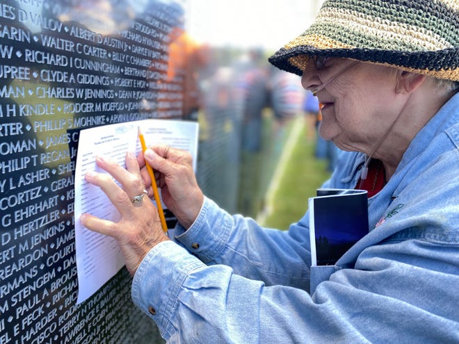 Rosella McCreary of Battle Creek traces the name of her nephew, Richard D. Orlando, on The Wall That Heals Vietnam Veterans Memorial Replica at Harper Creek Community Schools in Emmett Township on Thursday, July 14, 2022.