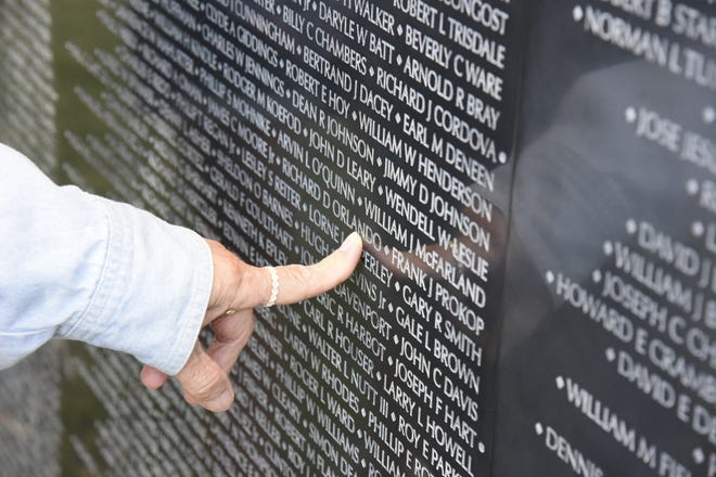 Rosella McCreary of Battle Creek locates the name of her nephew, Richard D. Orlando, on The Wall That Heals Vietnam Veterans Memorial Replica at Harper Creek Community Schools in Emmett Township on Thursday, July 14, 2022.