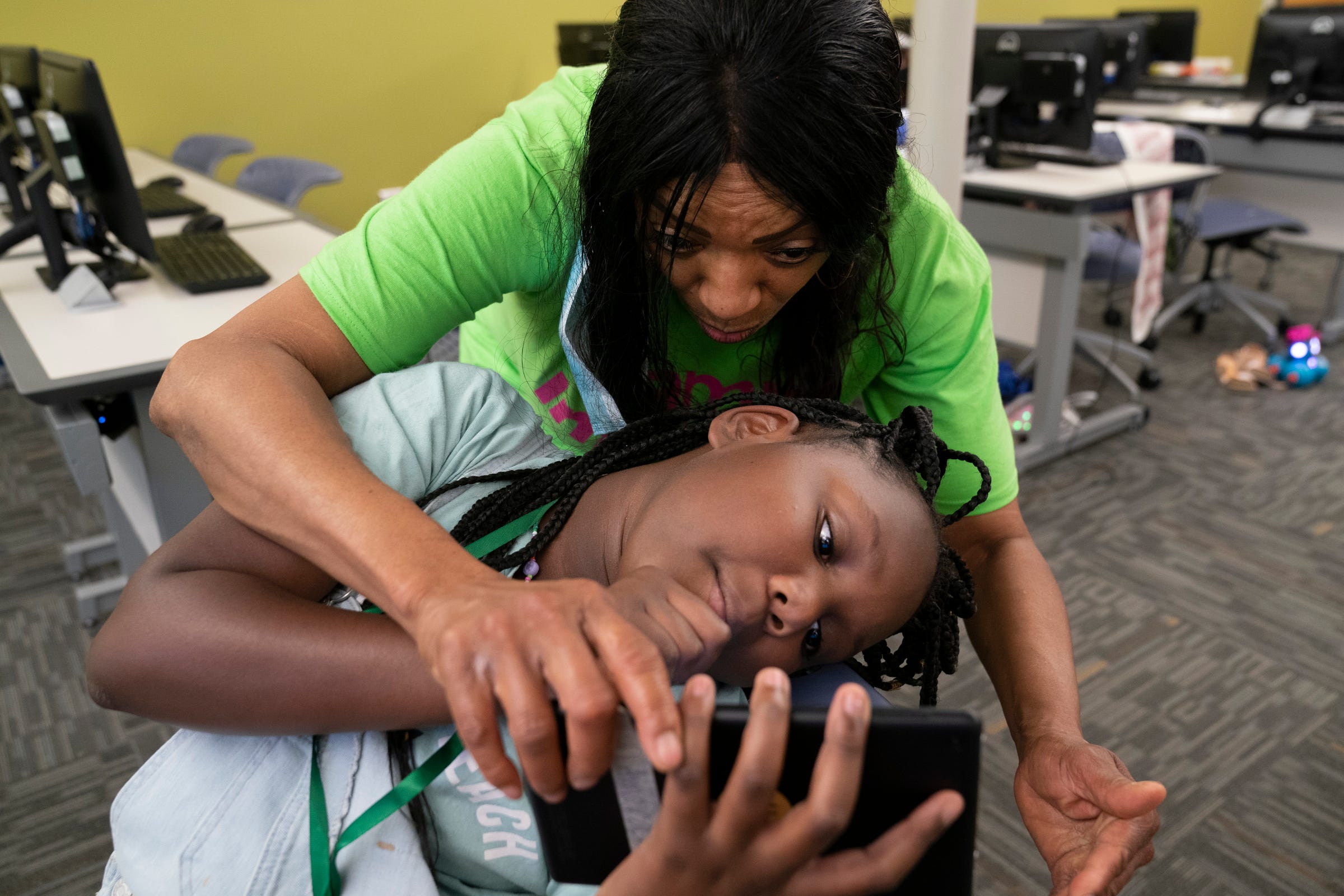 Instructor Genie Davis, top, works with Amora Kimball, 10, visiting from Ohio for the summer, during Camp Infinity hosted by the Michigan Council of Women Technology Foundation Wednesday, July 13, 2022 at the Wayne County Community College District Center for Learning in Harper Woods.