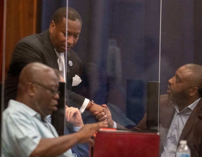 Memphis-Shelby County Schools Superintendent Joris Ray shakes hands with other board members following a Memphis-Shelby County Schools board special called meeting Wednesday, July 13, 2022, in Memphis. Attendees of the meeting discussed an investigation into Ray concerning "allegations of impropriety.” During the meeting, the board voted 7-2 to select an attorney. Ray was also placed on administrative leave. 