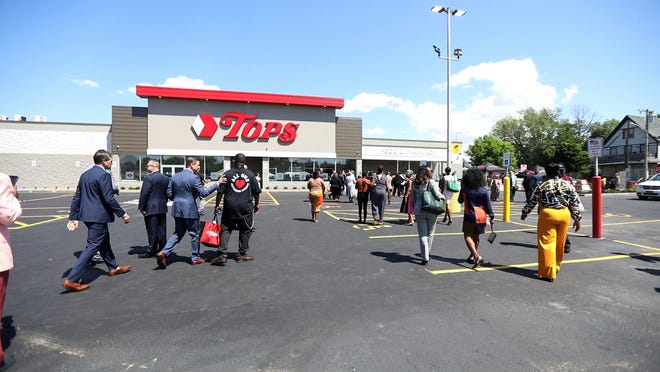 Tops Friendly Market officials enter the renovated Jefferson Avenue store in Buffalo.