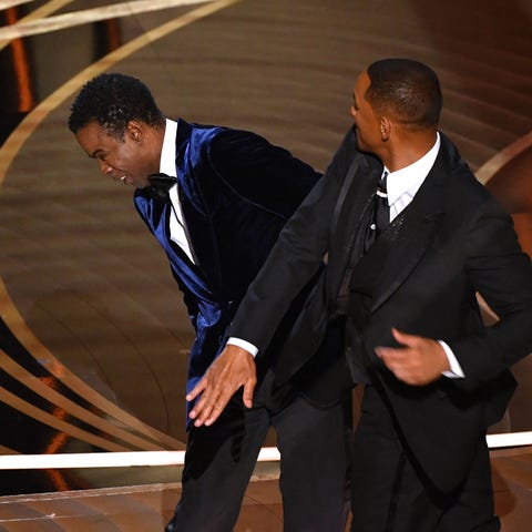 TOPSHOT - US actor Will Smith (R) slaps US actor C