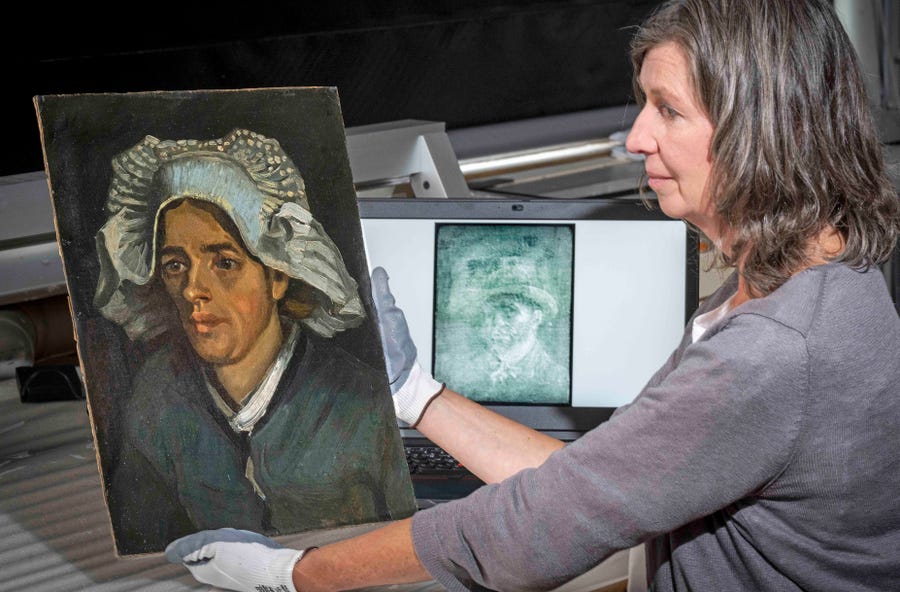 Senior Conservator Lesley Stevenson views Head of a Peasant Woman alongside an x ray image of the hidden Van Gogh self portrait.