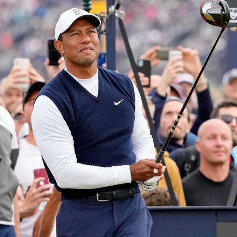 Tiger Woods tees off on the fourth hole during the